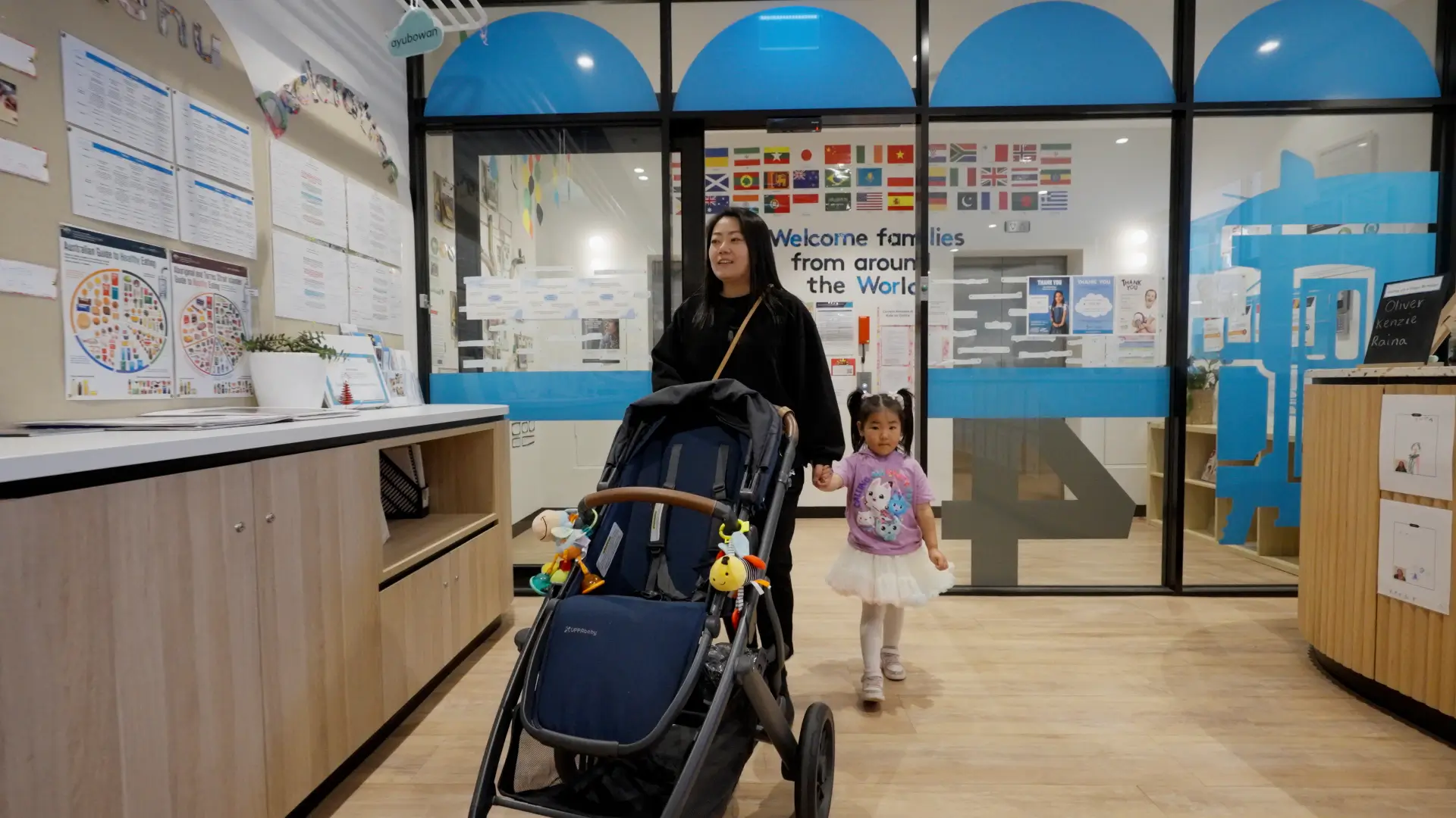 A mother is taking her childerns to child care
